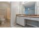 A bathroom offers a vanity with storage and ample counter space, plus a shower and tub at 8350 Gledstone Way, Fairburn, GA 30213