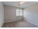 Carpeted bedroom features ample natural light and closet at 8350 Gledstone Way, Fairburn, GA 30213