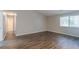 Spacious bedroom features modern wood-look flooring and natural light at 8350 Gledstone Way, Fairburn, GA 30213
