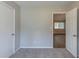 Carpeted bedroom features open doorway and spacious closet at 8350 Gledstone Way, Fairburn, GA 30213