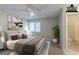 Bright bedroom with a ceiling fan, window, and access to the bathroom at 8350 Gledstone Way, Fairburn, GA 30213
