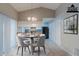 Staged dining area featuring table set, pendant lighting, and easy access to the kitchen at 8350 Gledstone Way, Fairburn, GA 30213