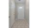 Bright entryway with light tile flooring and a white front door with a decorative window at 8350 Gledstone Way, Fairburn, GA 30213