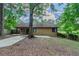 Charming single-story house with a cozy porch and mature trees in the front yard at 8350 Gledstone Way, Fairburn, GA 30213