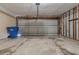 A bare garage, offering potential for parking and storage, featuring a roll-up door at 8350 Gledstone Way, Fairburn, GA 30213