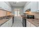 Functional kitchen with white cabinetry, dark appliances, and easy-to-clean tile flooring at 8350 Gledstone Way, Fairburn, GA 30213