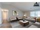 Bright living room features modern furnishings, natural light and new flooring at 8350 Gledstone Way, Fairburn, GA 30213