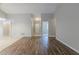 Open living room showcasing wood and tile flooring, light gray walls, and a welcoming entryway at 8350 Gledstone Way, Fairburn, GA 30213