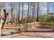 Wooden deck surrounded by tall trees in a well maintained backyard at 3017 Lana Ln, Marietta, GA 30066
