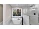 The bathroom features a modern soaking tub next to a glass enclosed shower and a view of the forest at 3017 Lana Ln, Marietta, GA 30066