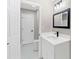 Small bathroom with white vanity, modern light fixture, and framed mirror at 3017 Lana Ln, Marietta, GA 30066