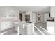 Bright, modern kitchen features an island, stainless steel appliances, white cabinets, and tile flooring at 3017 Lana Ln, Marietta, GA 30066