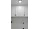 Functional laundry room features clean, white cabinets, utility connections, and a modern ceiling light at 3017 Lana Ln, Marietta, GA 30066