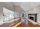 Spacious living room with fireplace, hardwood floors, and vaulted ceilings next to open kitchen area at 3017 Lana Ln, Marietta, GA 30066