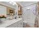 Bright bathroom features a tub with shower, floral shower curtain, and a white vanity with decorative accents at 3480 Arbroath Dr, Douglasville, GA 30135