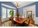 Dining room with bay windows, wood table set, and view of the front hallway at 3480 Arbroath Dr, Douglasville, GA 30135