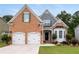 Charming brick home with well-manicured lawn, two-car garage, and inviting front porch at 3480 Arbroath Dr, Douglasville, GA 30135