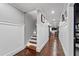 Bright hallway features hardwood flooring, wainscoting, and a staircase leading to upper levels of the home at 3480 Arbroath Dr, Douglasville, GA 30135