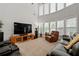 Bright living room featuring high ceilings, large windows, and comfortable leather seating at 3480 Arbroath Dr, Douglasville, GA 30135