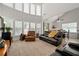 Spacious living room with large windows, leather seating, and ample natural light at 3480 Arbroath Dr, Douglasville, GA 30135