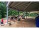Covered patio with stone pavers, seating area, and wooded views beyond at 3480 Arbroath Dr, Douglasville, GA 30135