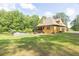 Expansive backyard featuring an in-ground pool, mature trees, and a well-maintained lawn at 3865 Pointer Rd, Loganville, GA 30052