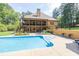 Beautiful backyard featuring a refreshing pool and an expansive two-story home at 3865 Pointer Rd, Loganville, GA 30052