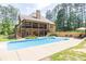 Private backyard oasis featuring a large pool, lush landscaping, and two-story home at 3865 Pointer Rd, Loganville, GA 30052