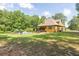 Well maintained backyard featuring an in-ground pool, mature trees, and a patio at 3865 Pointer Rd, Loganville, GA 30052