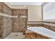 Bathroom showcasing a tiled shower and soaking tub, providing a spa-like experience at 3865 Pointer Rd, Loganville, GA 30052