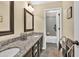This bathroom features a double sink vanity with granite countertops and a walk-in shower at 3865 Pointer Rd, Loganville, GA 30052