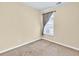Neutral bedroom with window dressed with light-filtering curtains and beige carpet at 3865 Pointer Rd, Loganville, GA 30052