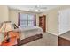 This bedroom offers natural light, neutral walls, a ceiling fan, and closet/cabinetry at 3865 Pointer Rd, Loganville, GA 30052