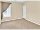 Neutral bedroom with window dressed with light-filtering curtains and beige carpet at 3865 Pointer Rd, Loganville, GA 30052