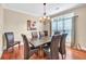 Elegant dining room with hardwood floors, a stylish chandelier, and large window at 3865 Pointer Rd, Loganville, GA 30052