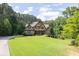 Beautiful home with lush green lawn and tree lined property at 3865 Pointer Rd, Loganville, GA 30052
