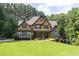 Charming two-story home with stone and siding exterior and manicured front lawn at 3865 Pointer Rd, Loganville, GA 30052