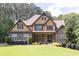 Charming home with stone accents, manicured lawn, and inviting covered front porch at 3865 Pointer Rd, Loganville, GA 30052