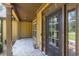 Covered front porch with stone tile, columns, and a stylish front door with sidelights at 3865 Pointer Rd, Loganville, GA 30052