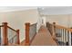 Hallway with wood railings leading to the stairwell at 3865 Pointer Rd, Loganville, GA 30052
