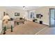 Spacious living room featuring beige carpet and access to outdoor patio at 3865 Pointer Rd, Loganville, GA 30052