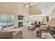 Bright living room with large windows, a fireplace, and an open layout to the kitchen and dining area at 3865 Pointer Rd, Loganville, GA 30052