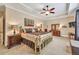Main bedroom with a tray ceiling, carpet flooring, and well-lit furniture at 3865 Pointer Rd, Loganville, GA 30052