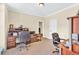 Spacious office featuring a dark wood desk and a leather chair at 3865 Pointer Rd, Loganville, GA 30052