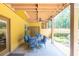 Covered patio with seating and ceiling fan, ideal for outdoor dining and relaxation at 3865 Pointer Rd, Loganville, GA 30052