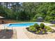 Stunning pool area surrounded by lush greenery and landscaped gardens at 3865 Pointer Rd, Loganville, GA 30052
