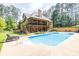 Backyard view featuring a sparkling blue pool and multi-level deck with ample seating at 3865 Pointer Rd, Loganville, GA 30052