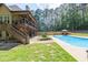 Beautiful pool area with multi-level deck and lush landscaping for outdoor enjoyment at 3865 Pointer Rd, Loganville, GA 30052