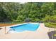 Inviting swimming pool set against a backdrop of mature trees at 3865 Pointer Rd, Loganville, GA 30052