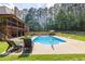 Inviting backyard pool surrounded by lush greenery and lounge chairs for relaxation at 3865 Pointer Rd, Loganville, GA 30052